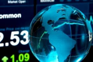 Glass Globe over Stock Data on Computer Screen
