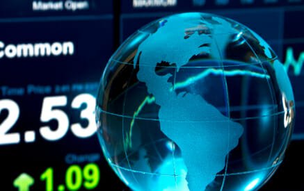 Glass Globe over Stock Data on Computer Screen