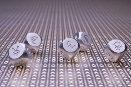 Metal dice with the currency symbols of Europe, England, United States, Russia, Japan, and China on a steel mesh background
