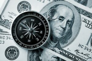 Compass on hundred dollar background