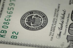 photo of federal reserve system symbol on hundred dollar bill