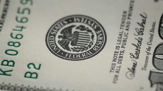 photo of federal reserve system symbol on hundred dollar bill