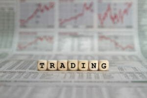 Trading in words on wooden blocks with newspaper background