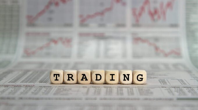 Trading in words on wooden blocks with newspaper background